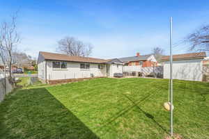 Back of property with a fenced backyard, a patio area, an outdoor structure, and a gate