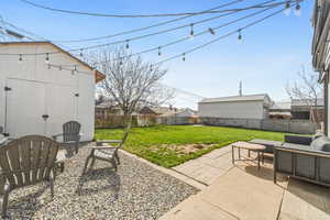 Fenced backyard with a patio and outdoor lounge area