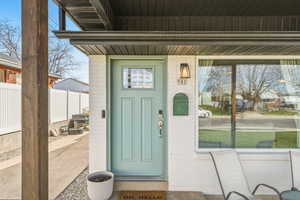 Doorway to property with covered porch