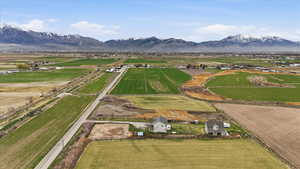 Overview of rural landscape featuring a mountain backdrop and abundant farmland