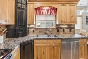 Kitchen featuring stainless steel appliances, backsplash, and healthy amount of natural light