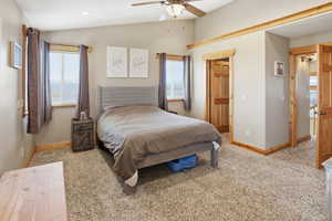 Priimay Bedroom featuring vaulted ceiling, light colored carpet, a ceiling fan, recessed lighting, and a spacious walk-in closet.