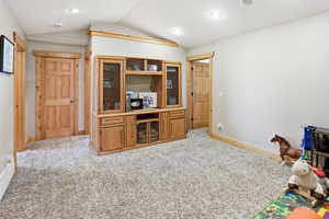Office area featuring light carpet and baseboards
