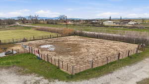 View of yard featuring an enclosed riding area, a rural view, and a mountain view