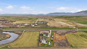 Overview of rural landscape with a water and mountain view and extensive farmland