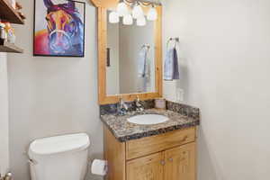 Half bathroom with vanity and toilet