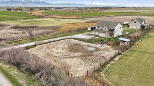View of horse arena, home, and workshop/ADU and horse stalls.