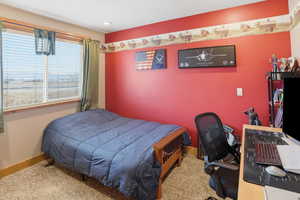 Bedroom featuring carpet flooring and an office area