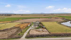 Overview of rural landscape with a mountain backdrop and rows of crops