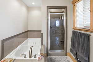 Primaryl bathroom  ensuite with a tub with jets and a stall shower