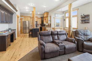 Living room with light wood finished floors and a chandelier