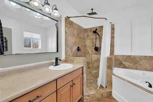 Full bath with a shower stall, a bath, crown molding, and vanity