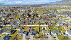 Aerial overview of property's location with a mountainous background and nearby suburban area