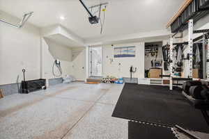 Garage with electric vehicle charger and epoxy floor.