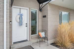 Entrance to property featuring brick siding