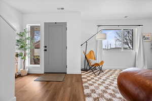 Entrance /foyer accompanied by large framed entry window and LVP flooring.