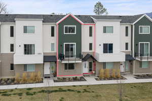 View of front of property with roof with shingles and a front yard
