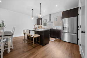 Spacious kitchen featuring state of the art appliances, quartz countertops, and decorative pendant lighting.