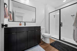 Full Owner's Suite bathroom featuring vanity with quartz countertops, shower, and LVP flooring.