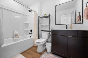 Full upstairs bathroom with solid wood cabinetry, quartz countertop, and LVP flooring.