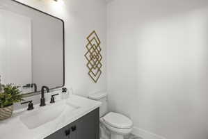 Half bath with vanity and toilet