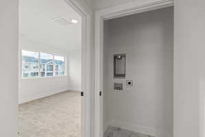 Laundry area with washer hookup, light marble finish flooring, electric dryer hookup, and recessed lighting
