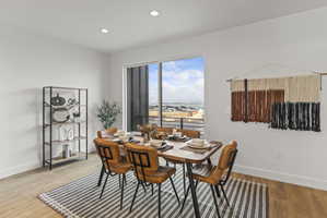 Dining area featuring light wood-style flooring and recessed lighting