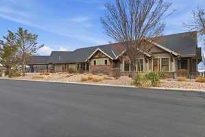 Craftsman inspired home with stone siding and a shingled roof