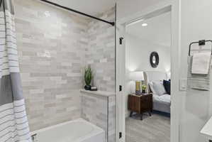 Full bath with ensuite bath, recessed lighting, shower / bath combo, and light colored carpet