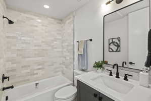 Full bath with vanity, shower / tub combination, and recessed lighting