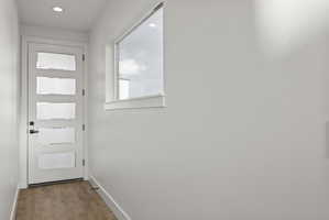 Doorway to outside featuring wood finished floors and recessed lighting