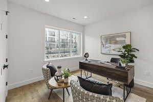 Office area featuring wood finished floors and recessed lighting