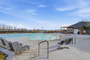 Community pool featuring a patio and a pergola
