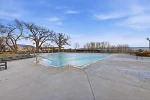 Community pool featuring a patio