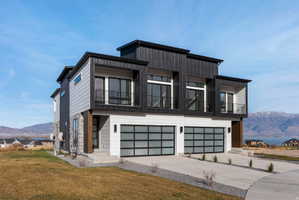 Modern multi-level exterior with black vertical siding and light grey horizontal siding