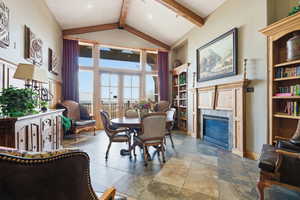 Dining area featuring french doors, a fireplace, and recessed lighting
