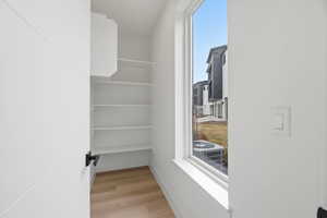 Walk in closet featuring light wood-type flooring