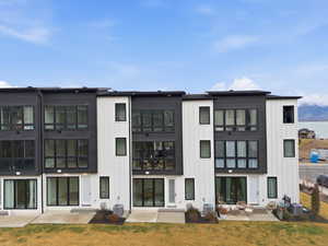 Back of house featuring a patio area and board and batten siding