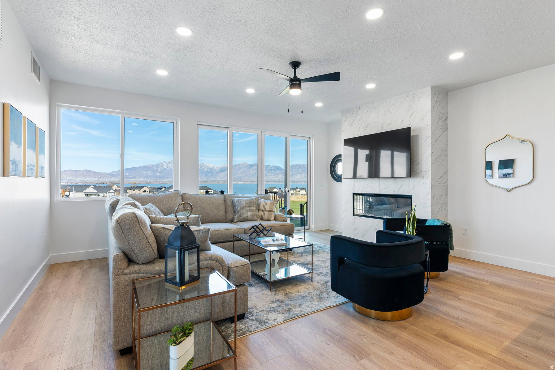 Bright living area with wood-finish flooring and recessed lighting