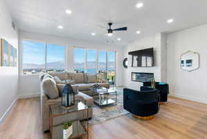 Bright living area with wood-finish flooring and recessed lighting