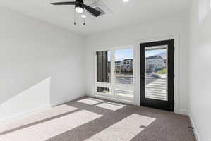Bright room featuring a black ceiling fan, recessed lighting, white walls, and neutral carpeting