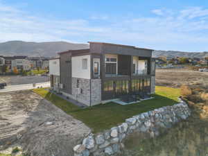Modern multi-level residence featuring a composite siding and stone facade