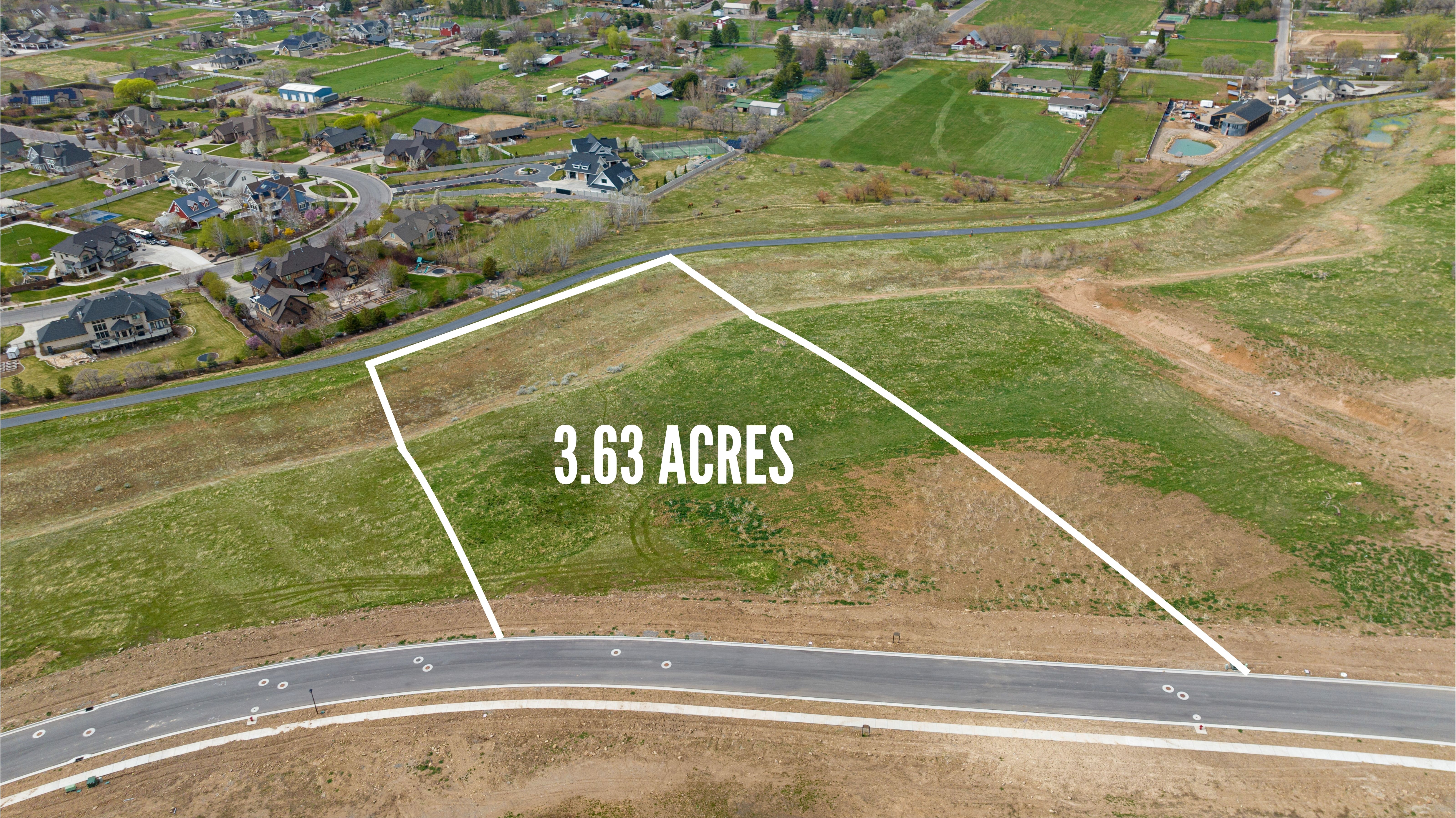 Aerial view of property and surrounding area featuring property parcel outlined