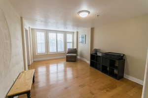 Sitting room featuring a textured ceiling and light wood finished floors