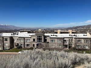 Back of property with a mountain view and stucco siding
