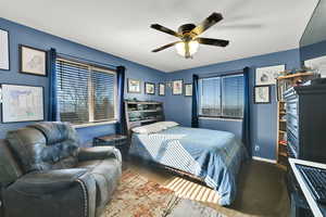 Bedroom with a ceiling fan and carpet floors
