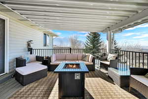 View of patio with an outdoor living space with a fire pit and a mountain view