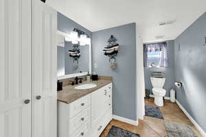 Bathroom with vanity, a shower with shower curtain, and light tile patterned floors