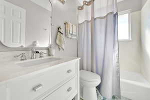 Full bath with vanity and shower / bath combo with shower curtain