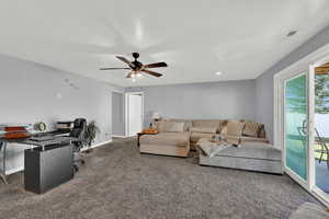 Living area featuring a desk, carpet floors, a ceiling fan, and recessed lighting